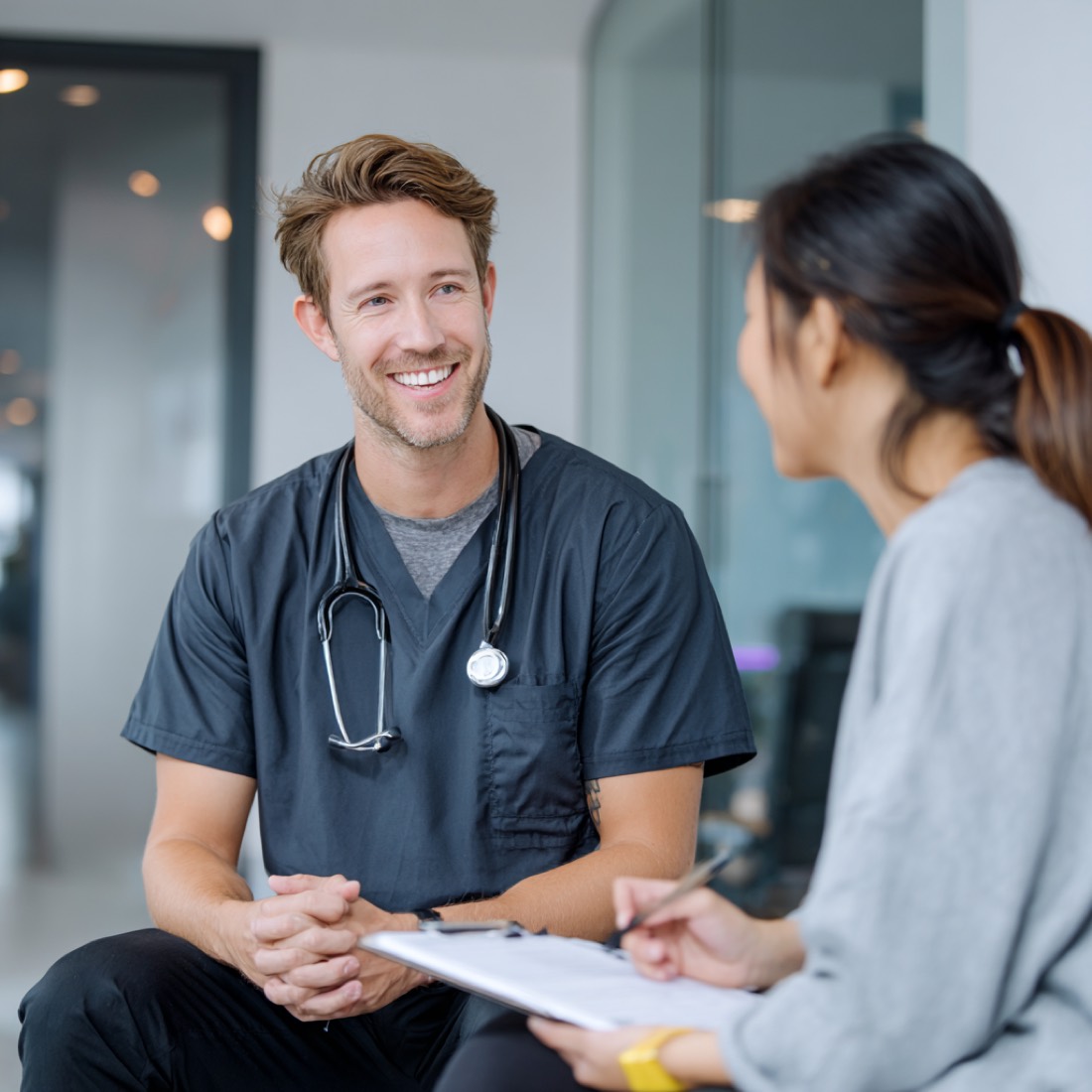 A Premier Health Alliance clinician in conversation with a patient